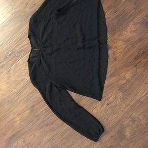 Sheer, polkadotted, long sleeved blouse.